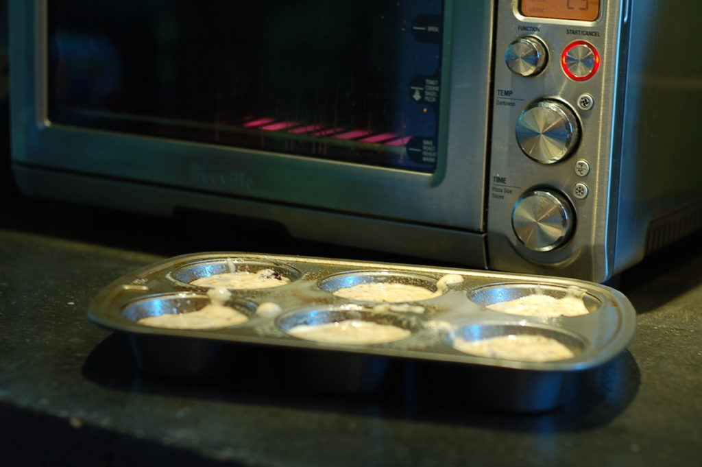 Prebaked muffins in tin by toaster