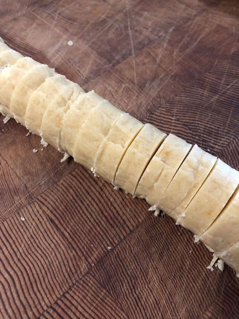 Sliced log of dough for vacation cookies.